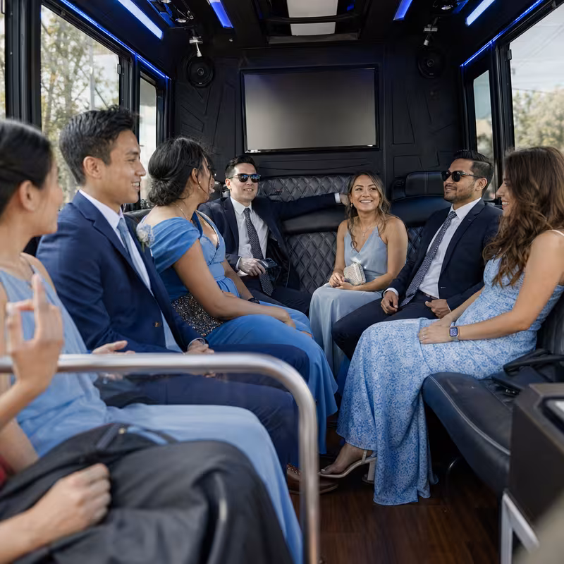 Wedding guests seated inside a Pasadena party bus