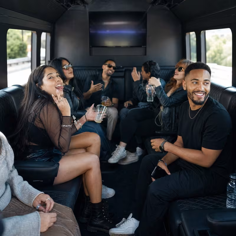 Group boarding a white charter bus for Concert Transportation transportation in Pasadena