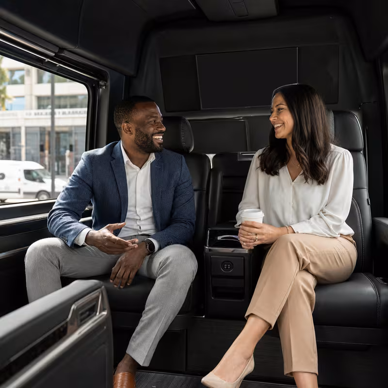 Group boarding a white charter bus for Corporate Transportation transportation in Pasadena