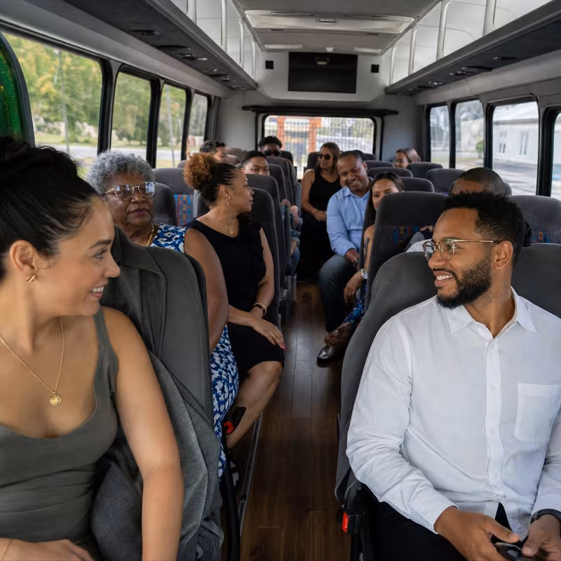 Group boarding a white charter bus for Private Event Transportation transportation in Pasadena
