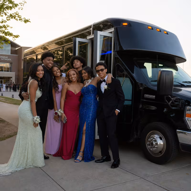 Group boarding a white charter bus for Prom & Homecoming Transportation transportation in Pasadena