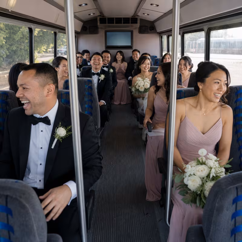 Group boarding a white charter bus for Wedding Transportation transportation in Pasadena