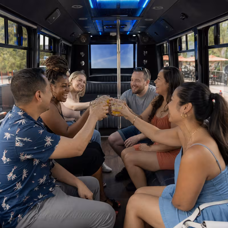 Group boarding a white charter bus for Winery & Brewery Tour Transportation transportation in Pasadena